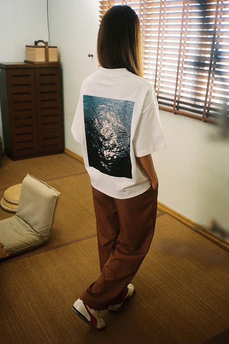 Zoey wearing P001 "Glimmer" T-Shirt, Studio Trousers. Photograph artwork by HIEP, MINUS-E.