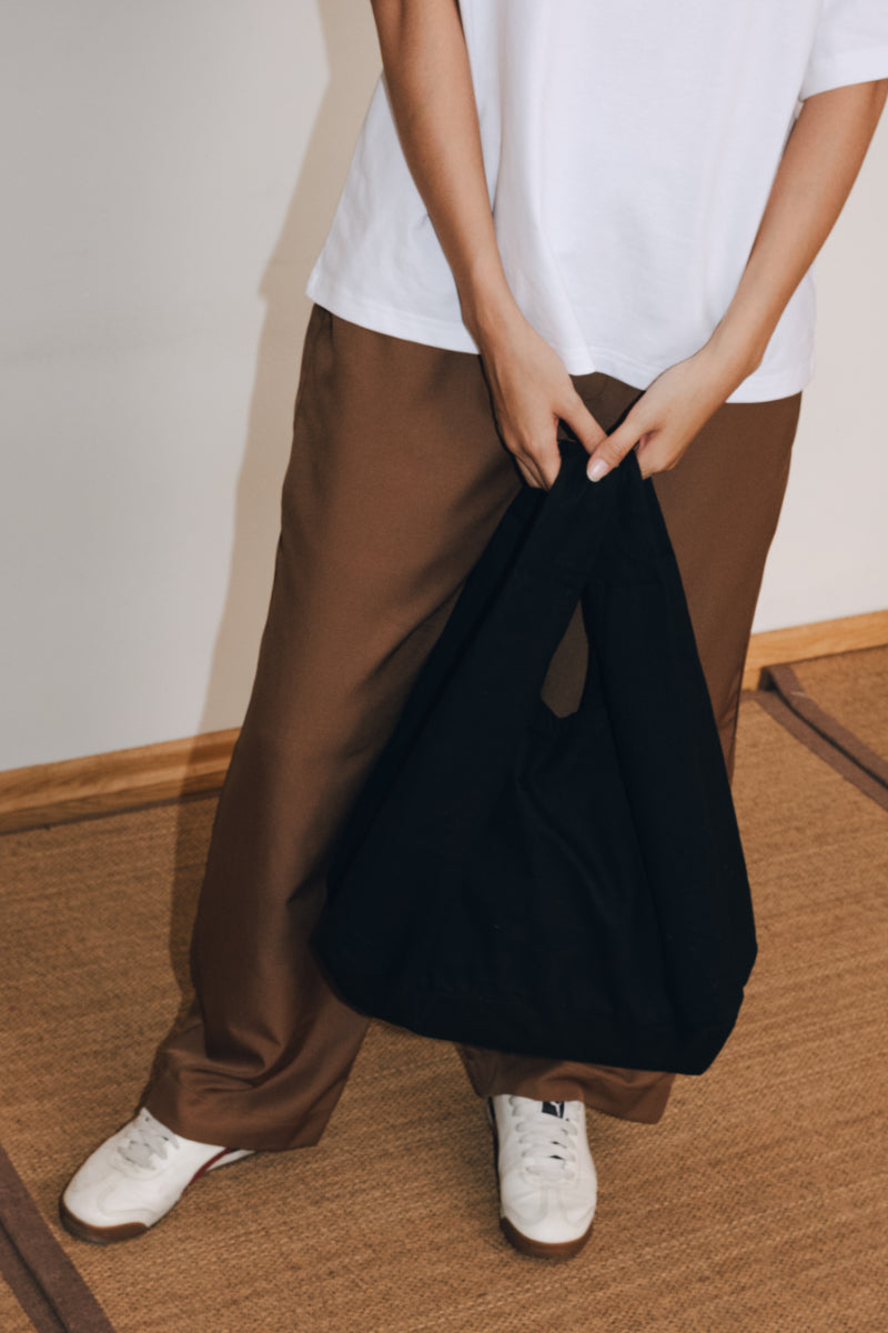 Model holding Tiny Shopper by MINUS-E.